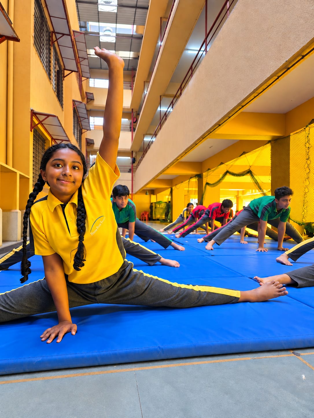 North Point School students practising gymnastics on blue mats